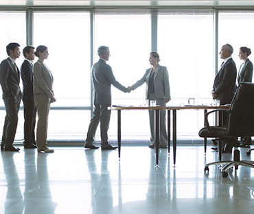 Business people shaking hands in conference room