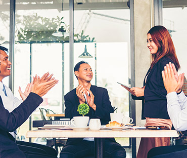 business partners clapping hands to a success business woman