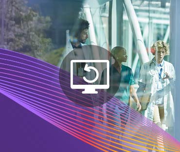 Doctors discussing while walking on elevated walkway