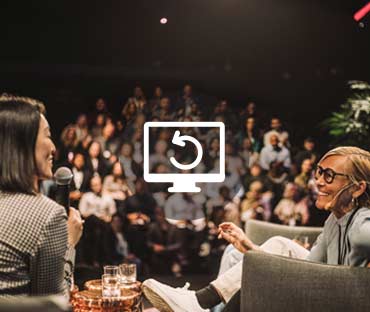 Interviewer interacting with smiling entrepreneurs