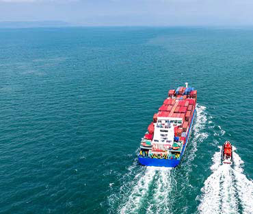 ship and a pilot boat sailing at sea wo