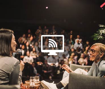 Interviewer interacting with smiling entrepreneurs