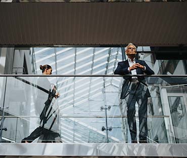 View of businesswoman walking by businessman