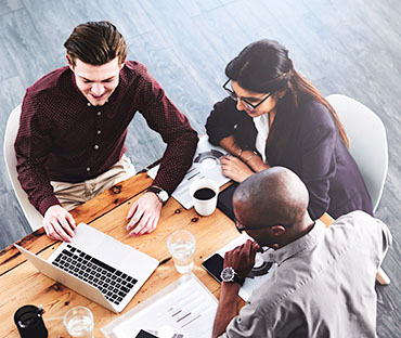 A group of businesspeople using a laptop