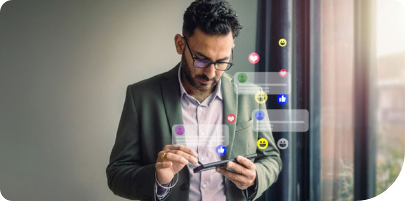 Professional using mobile phone with social media reactions floating